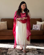 Dhwani wearing premium mul chanderi white anarkali suit with red bandhani dupatta – Go Desi Canada