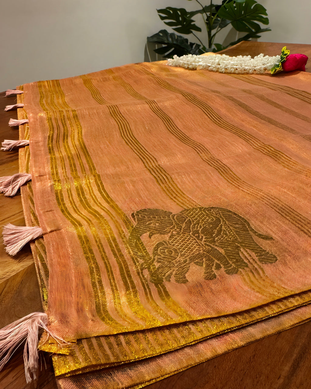 Decorative table runner with elephant design on a wooden surface