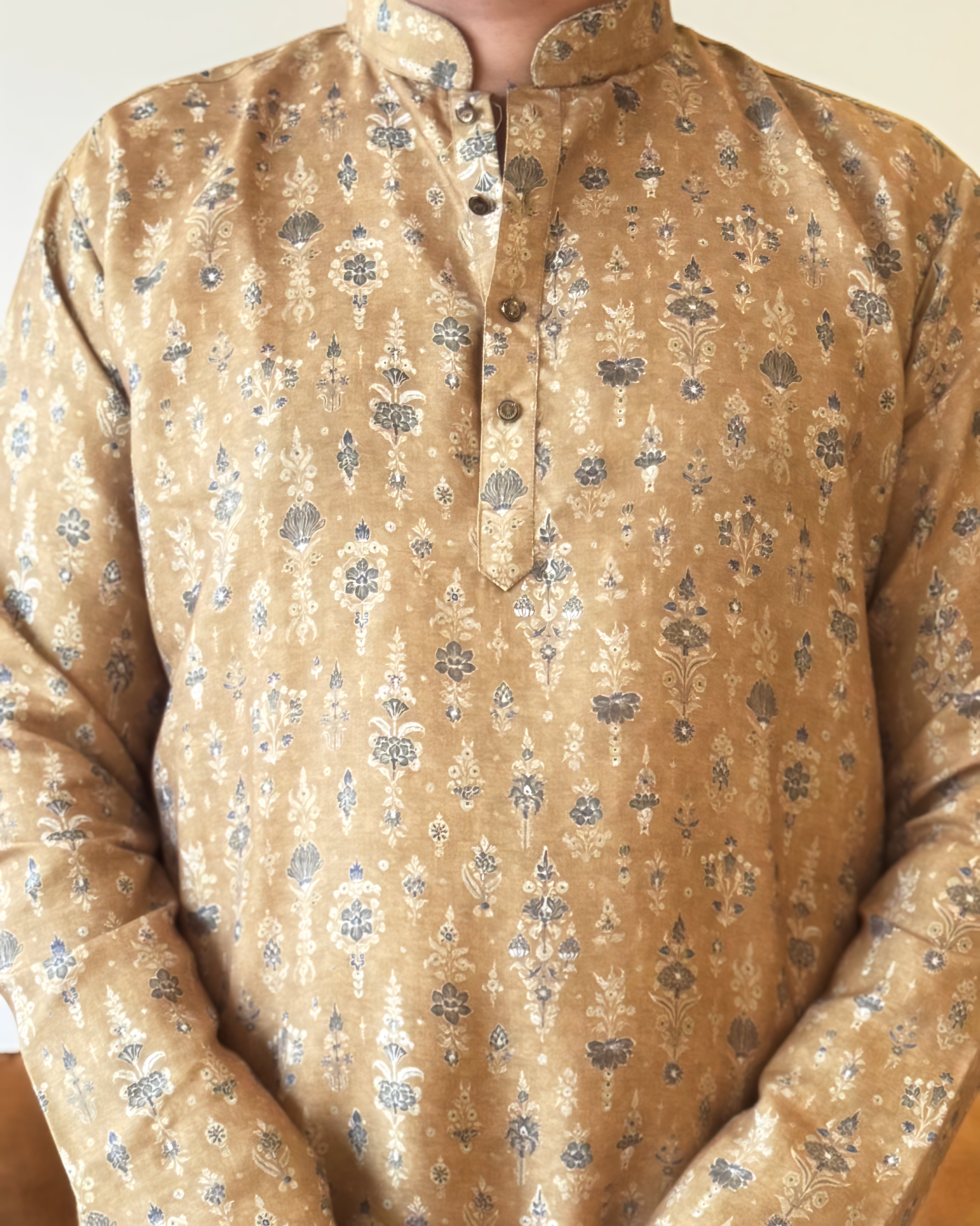 Beige kurta with floral pattern worn by a person