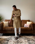 Man wearing a traditional kurta in a living room setting
