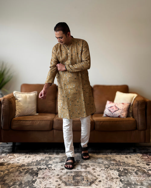 Man wearing a traditional kurta in a living room setting