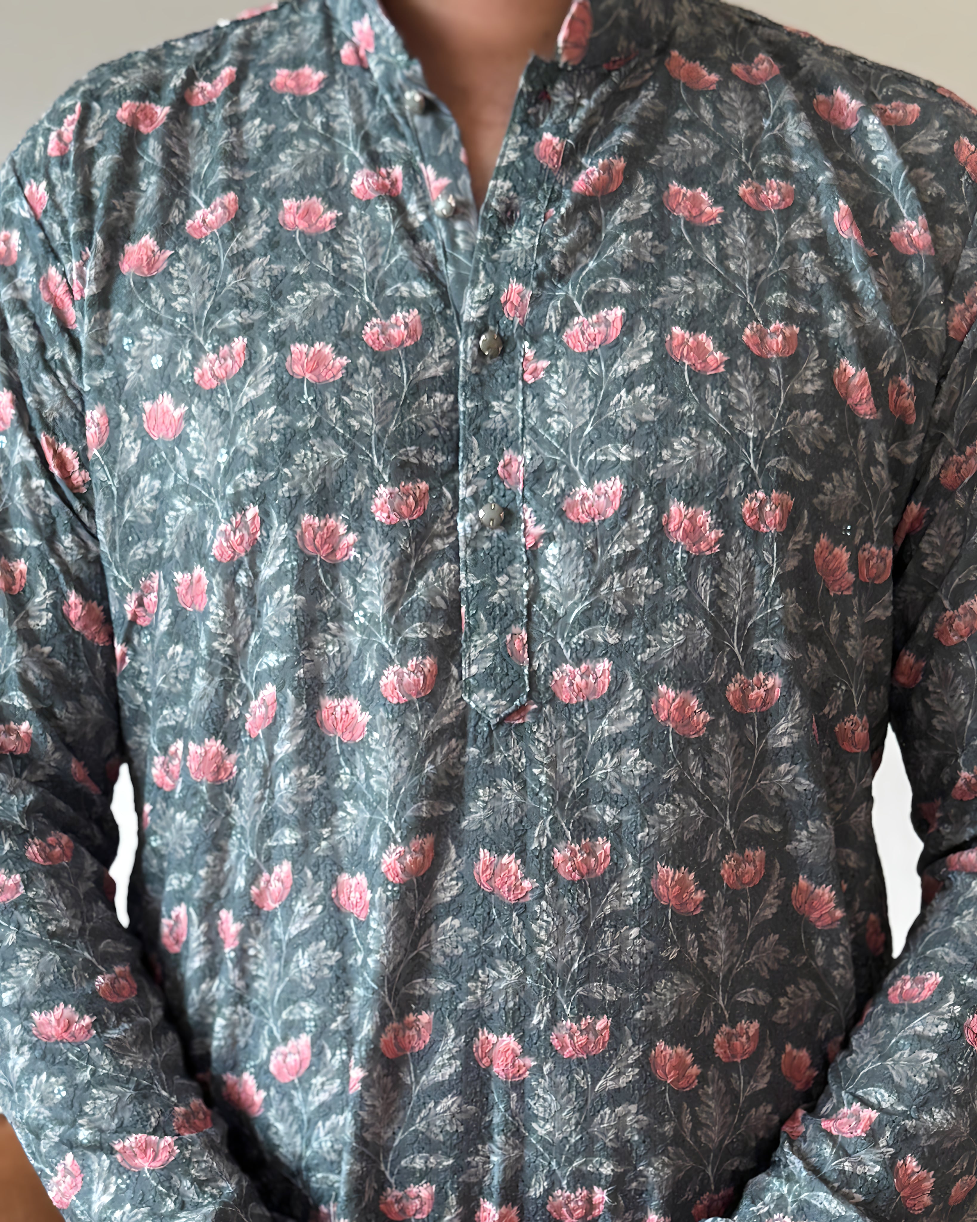 Floral patterned shirt with pink flowers on a dark background