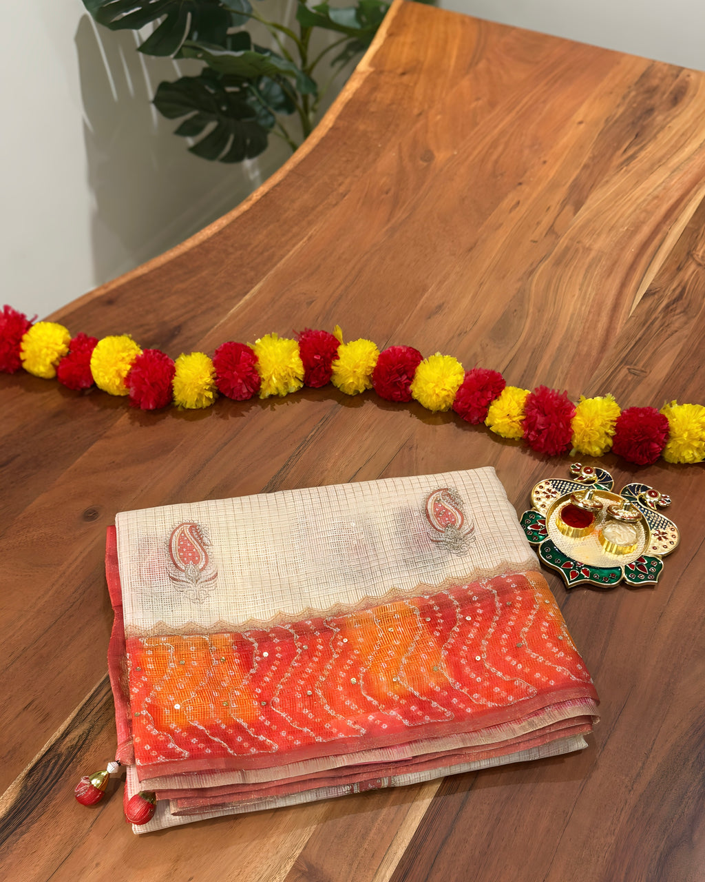 Stack of colorful fabric with a decorative garland on a wooden surface