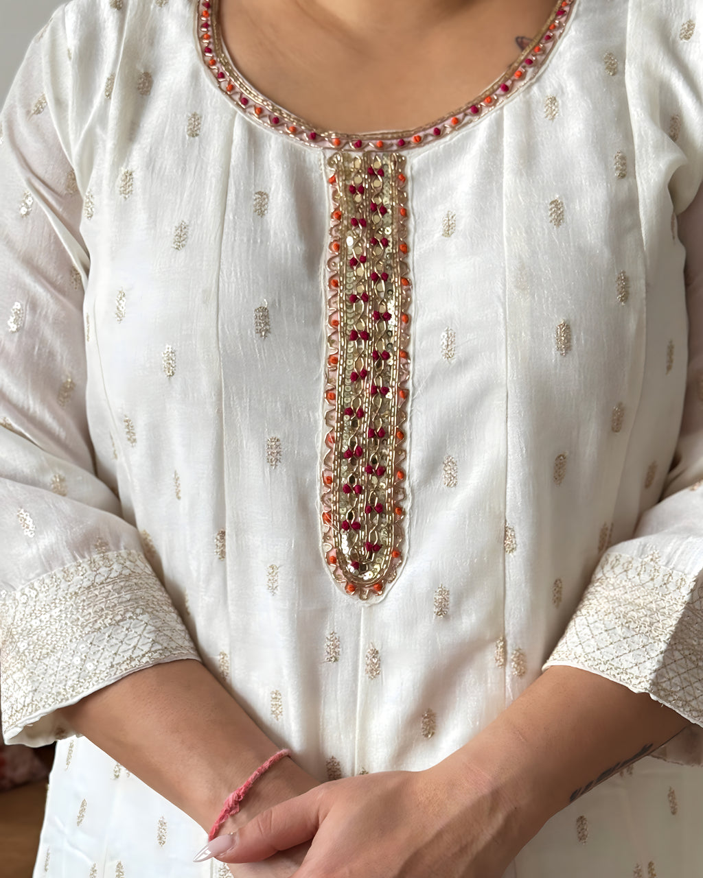 Close-up of a white embroidered kurta with intricate patterns