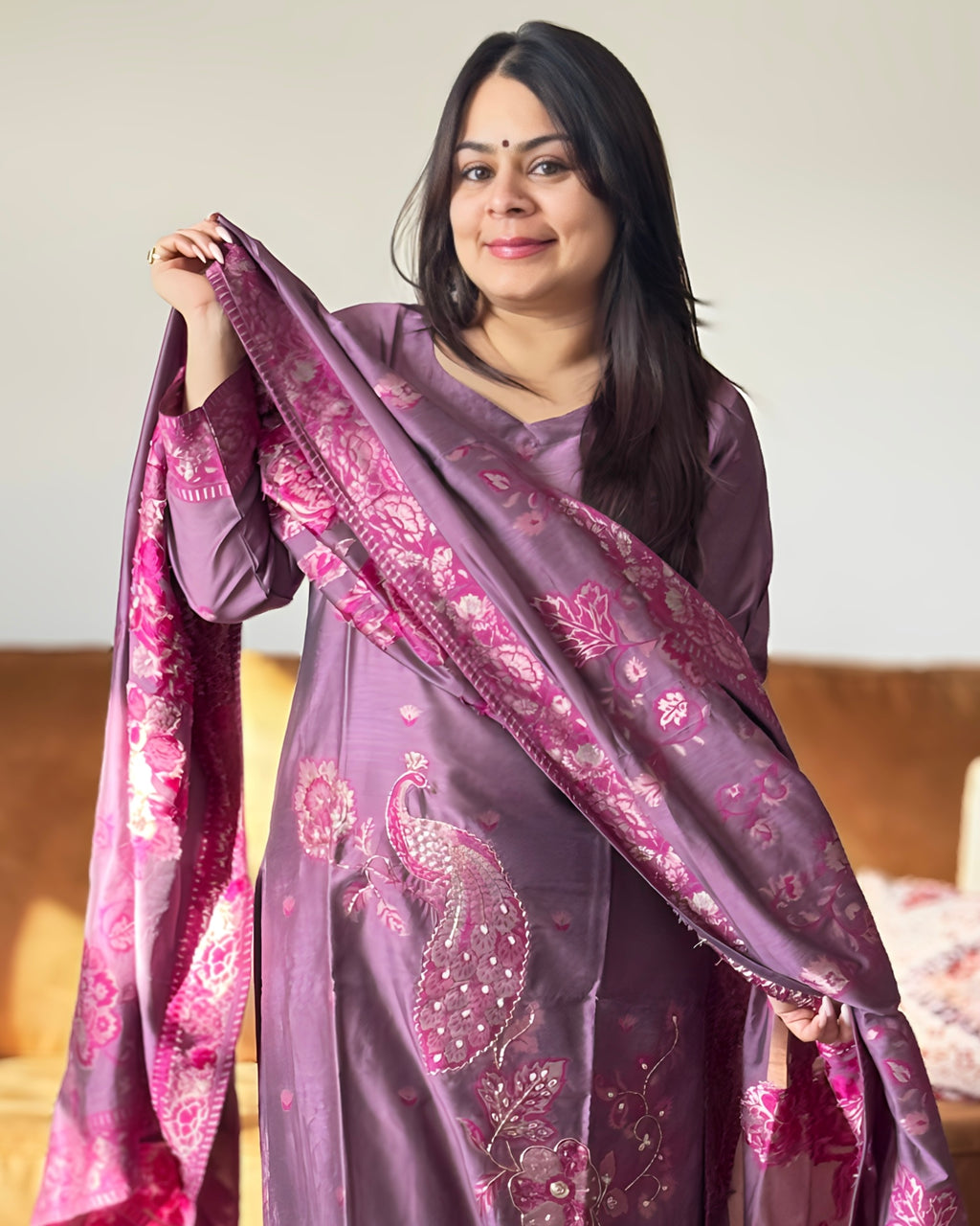 Woman holding a purple and pink patterned scarf