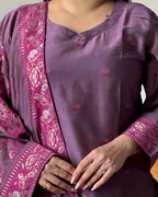 Purple traditional outfit with intricate patterns on a plain background