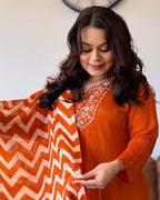 Woman holding an orange and white patterned fabric