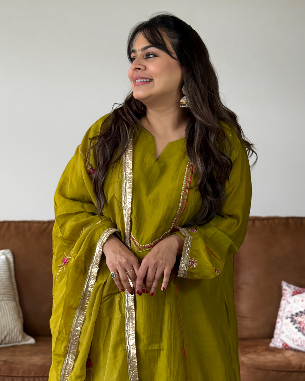 Parrot green Mul Chanderi women’s suit set with gold floral detailing, pink accents, matching pants, and dupatta.