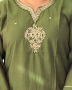 Green embroidered garment with intricate patterns