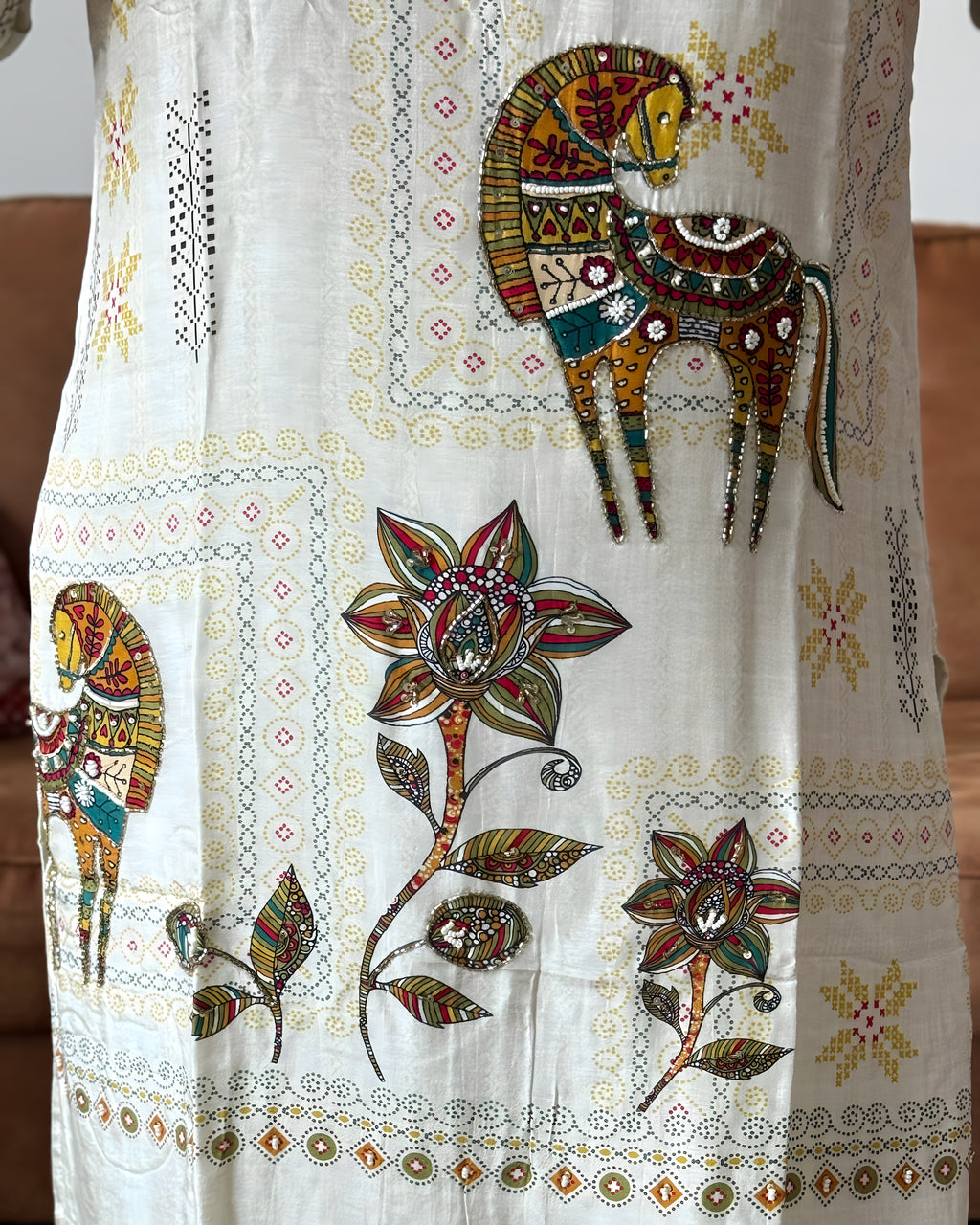 Decorative fabric with embroidered animals and flowers on a white background