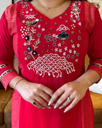 Red embroidered dress with intricate patterns on a blurred background