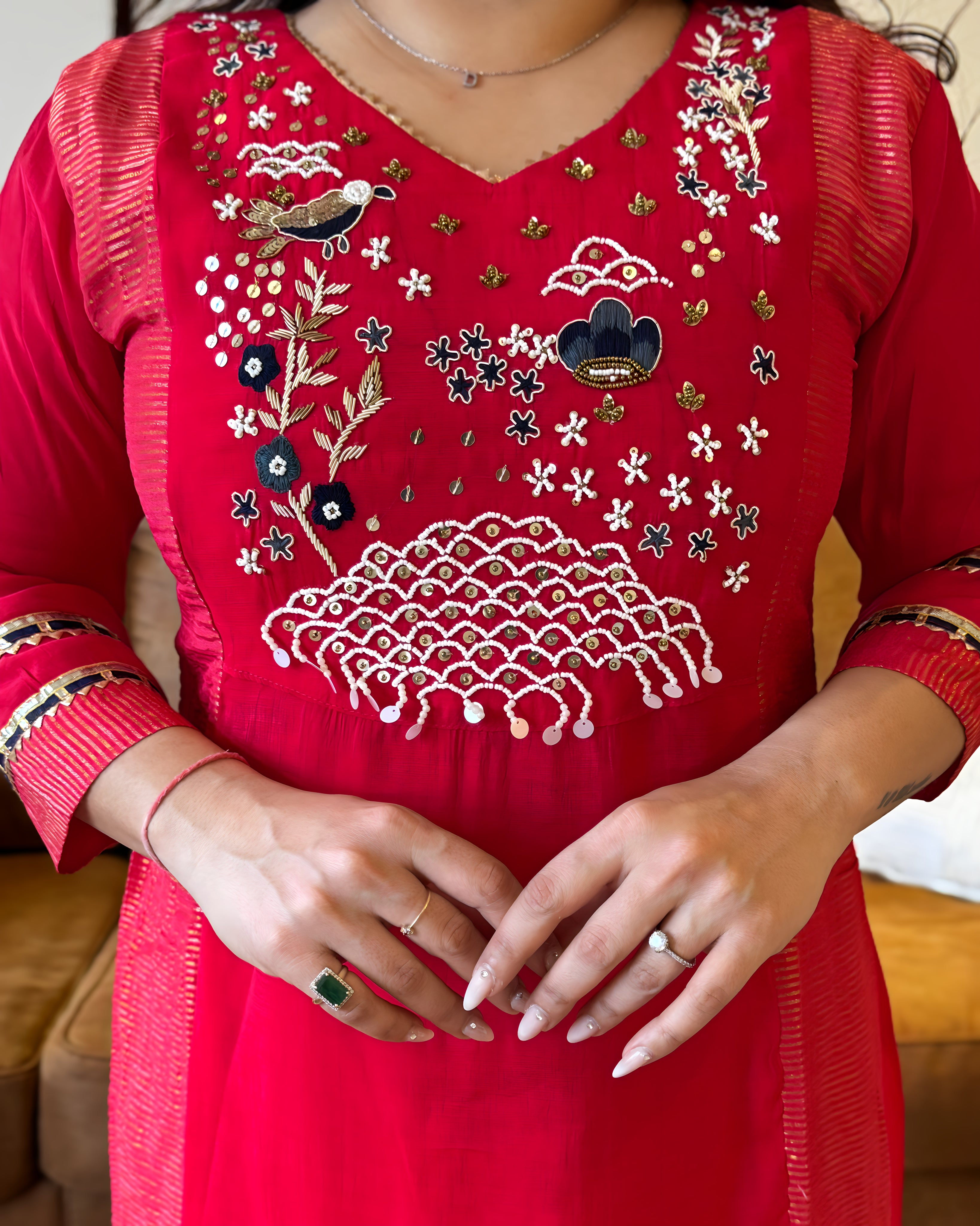 Red embroidered dress with intricate patterns on a blurred background