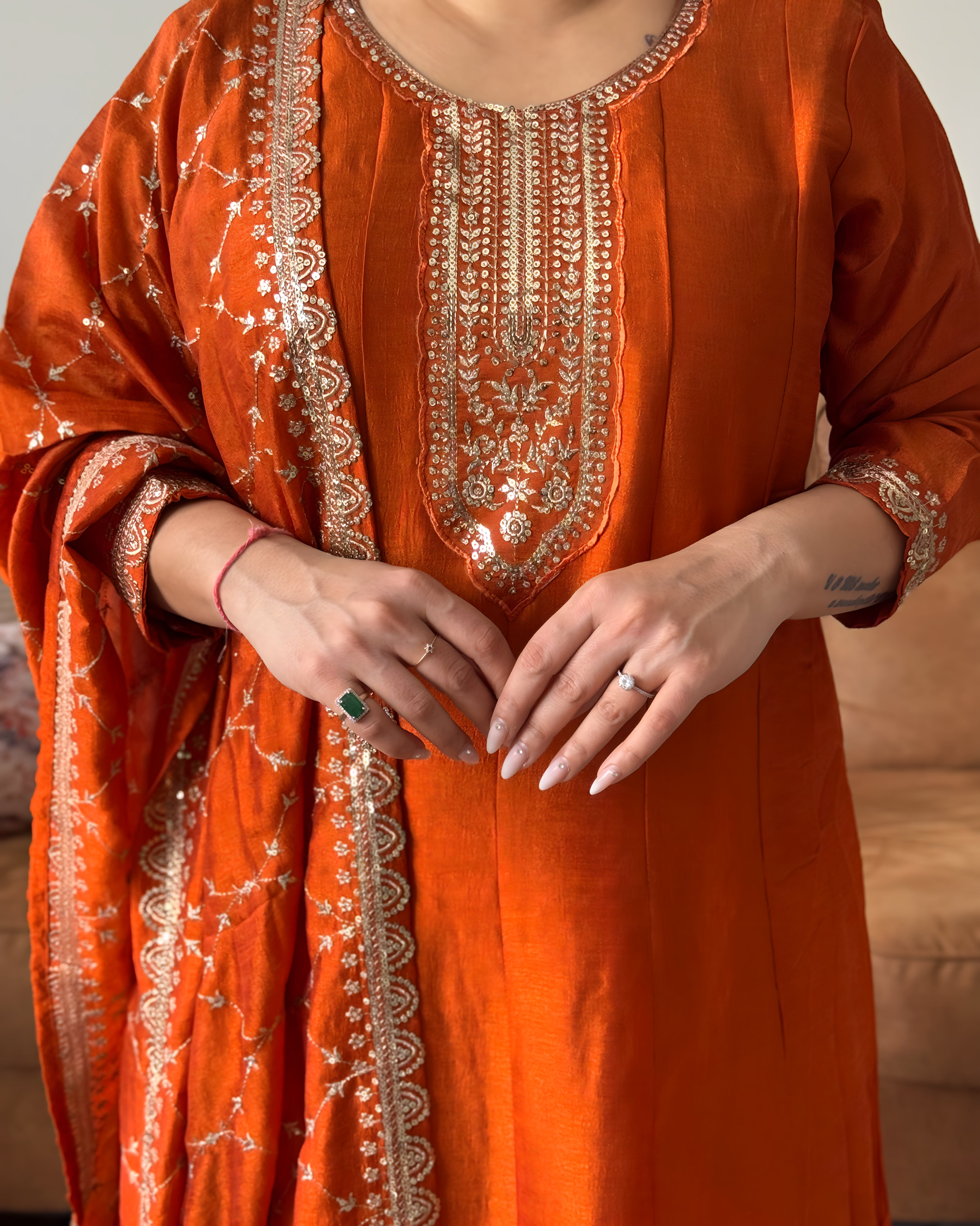 Orange traditional outfit with intricate gold embroidery