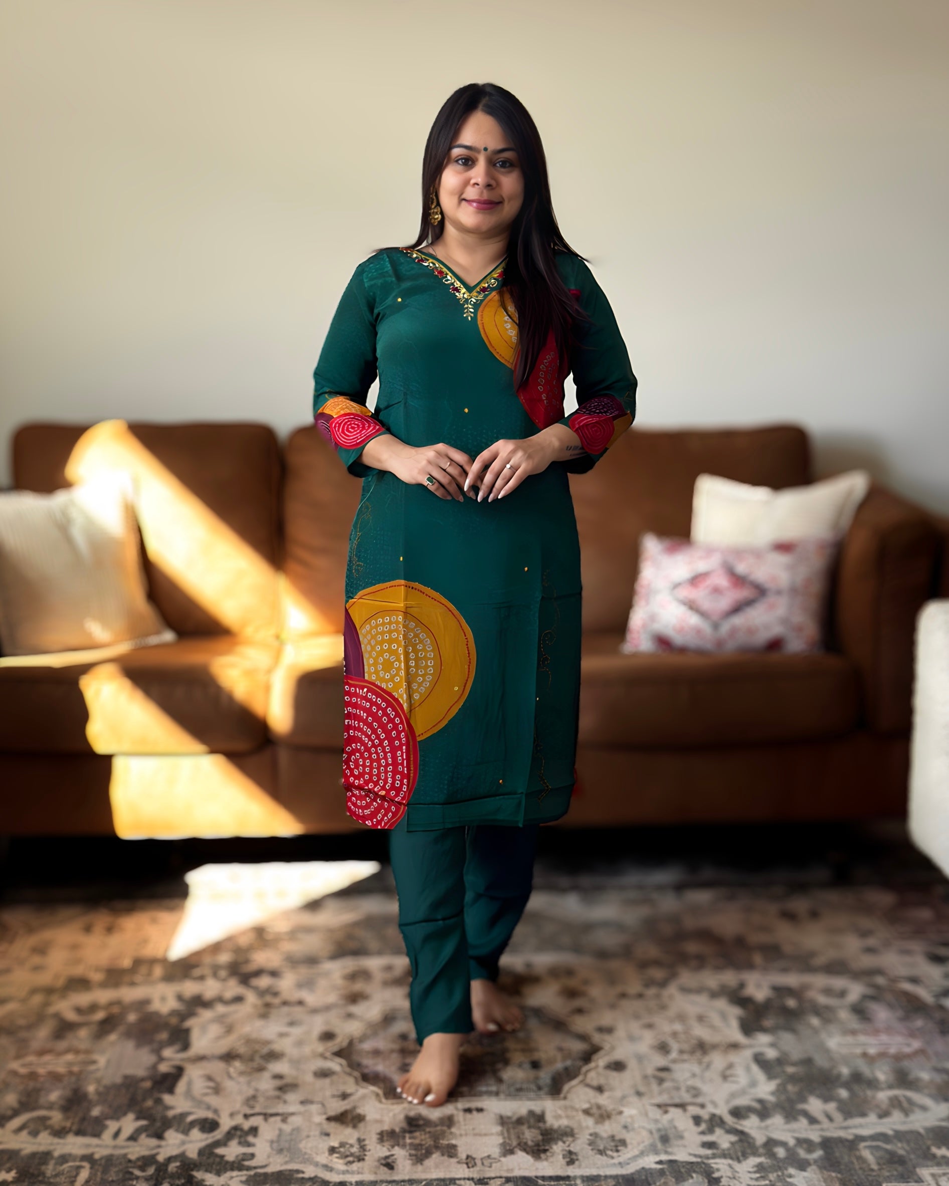 Woman in a green traditional outfit standing in a living room.